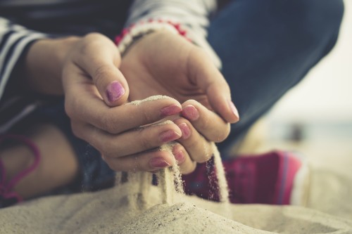 The sand in the female palms on the beach
