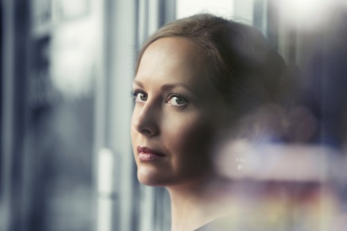 Sad beautiful woman looking out window